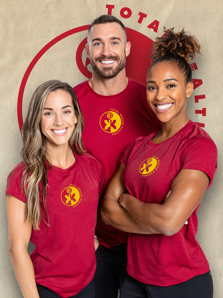 Michael Rodriguez, certified fitness specialist, wearing branded Total Health Systems red shirt, smiling warmly at camera